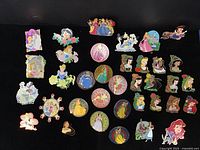 Full layout of all 36 Disney Princess trading pins on black background