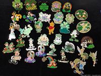 All 35 enamel trading pins laid out on black background