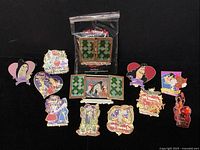 All 12 trading pins arranged on black background, showing varied Disney villains and Villaintine's Day holiday themes.