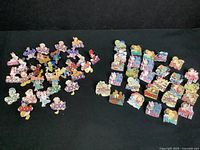 Photo showing a collection of Disney trading pins featuring the word 'Good' with various characters and additional word-themed pins like 'Discover', 'Music', and 'Parades'