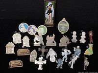 Full display of 26 Haunted Mansion trading pins laid flat on black background showing all character and themed designs.