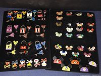 Two boards of enamel pins: left board contains character lock and key sets and poison bottle pins; right board contains earhat pins