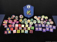 Overview of entire Pete’s Dragon pin collection laid out on black background