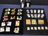 Two black pin boards showing mixed groups of Seeing Double, rectangular sketch pins, flip-book Sketch Pad pins, two packaged Animation Legends pins