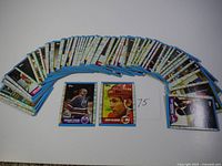 75 vintage Topps hockey cards fanned out showing the edges and back sides mostly