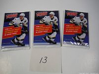 Three sealed Upper Deck Victory 2007-08 hockey card packs with Sidney Crosby on the front, placed side by side with a note '13' in front.