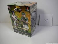 Front view of sealed 2021 Panini Illusions Football trading cards blaster box showing players Justin Fields and Zach Wilson and branding