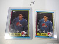 Two Joe Sakic rookie cards from Topps and O-Pee-Chee Anniversary Series.