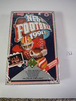 Front view of sealed 1991 Upper Deck NFL Football Factory box with football player in red and gold uniform and Premier Edition labeling.