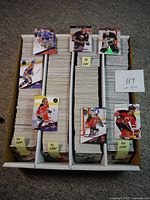 Full overview of the lot showing three boxes of stacked LEAF hockey cards from 1993 and 1994, labeled accordingly.
