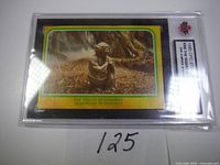 Front view of graded Star Wars Yoda rookie card in protective case.