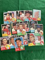 Photo of 17 1963 Topps baseball cards laid out showing player portraits and team logos.