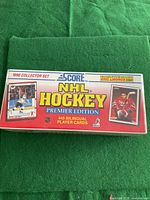Sealed box front showing 1990 Collector Set, Score brand NHL Hockey Premier Edition, 445 bilingual player cards, and images of Wayne Gretzky and Eric Lindros cards.