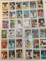 Full view of 36 hockey cards in plastic sleeve pages, showing the front side of the cards with players in hockey uniforms
