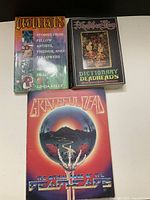 Three Grateful Dead related books laid flat showing covers: 'Deadheads' by Linda Kelly, 'Dictionary Deadheads', and 'Grateful Dead: The Official Book of the Deadheads'.