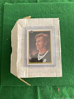 Card set stored in white cardboard box labeled 'Bowman 90/91' with the primary visible card of a smiling hockey player in protective sleeve on top.