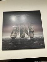 Front cover of Awolnation double LP album showing rocky island formations in ocean under night sky.