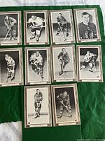 Top view of 10 vintage 1964-67 Chicago Blackhawks Beehive hockey cards arranged in two rows on a green surface, displaying black and white player photos with names beneath.