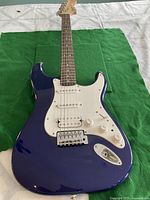 Front view of guitar body showing blue finish and white pickguard