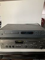 Front view of CD player stacked above receiver showing overall condition and model markings