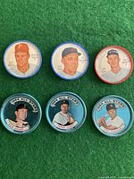 Six vintage Sheriff and Topps baseball coins arranged on green background showing player portraits and team info.