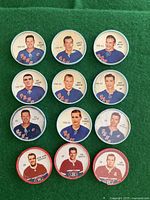 Photo showing all 12 vintage Shirriff hockey coins, with 9 New York Rangers players in blue jerseys and 3 Montreal Canadiens players in red jerseys.