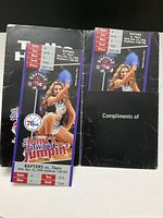 Photo showing two vintage Raptors tickets from November 13, 1996, with a cheerleader and Raptors logo on the front, indicating game details, section, row, seat, and price.