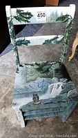 Front and top view of wooden chair showing mountain forest painted backrest and seat, owl with fish detail on seat, and crack near front.