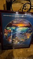 Framed Circle of Life print showing underwater scene and sunset