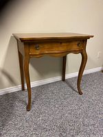 Full view of the antique solid wood desk showing top, drawer, legs and keyhole.
