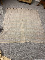 Curtains fully spread on the floor showing size and material texture.