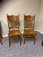Pair of solid wood farmhouse chairs, front view showing seat, legs, and backrest design
