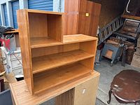 Front-left angled view showing the two shelves and single cubby storage