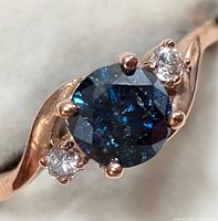 Top view of ring showing central blue diamond and side diamonds