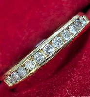 Close-up view of channel-set diamonds on red velvet background