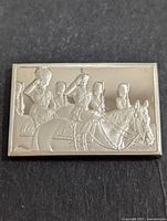 Front of silver bar with embossed image of mounted guards saluting on horseback