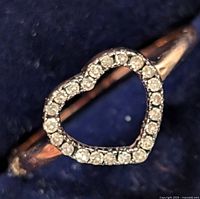 Close-up of the heart-shaped diamond ring showing the diamond outline on silver band.