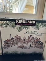 Box front showing the Kirkland Signature logo and image of the 40-piece lighted Victorian village set