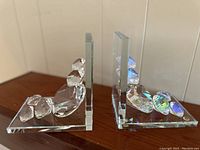 Side angled view of one crystal diamond bookend showing multiple faceted crystals of different sizes on glass base and vertical glass panel.