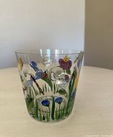 Side view showing hand painted floral and insect (butterflies, ladybug, dragonfly) decoration and air bubble inclusions in glass.