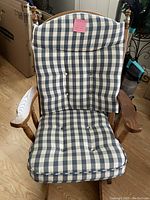 View of the full plaid oak glider rocker chair, showing the blue and white plaid cushions and oak wood frame with curved arms and turned legs.