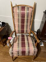 Front view of the plaid upholstered wooden armchair showing the backrest and seat pattern.