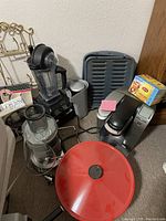 Overview of front section showing food processor bowl, Vitamix blender, red electric wok and Keurig brewer