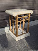 Front and top view of the vintage travertine and metal side table showing thick travertine top with rolled edges, rusted metal frame, and travertine base.