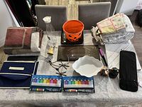 Overhead view of all items in lot arranged on table, showing variety of household, holiday, and storage items.