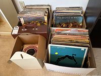 Two large boxes and one small box of vinyl records plus a patterned record case
