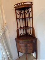 Full view of the mahogany-tone wooden corner shelving unit showing overall design and condition