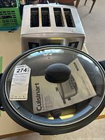 Photo showing the 4-slot toaster and Cuisinart slow cooker with lid and instruction booklet.