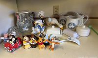 Overview of all kitchen decorative items including figurines, pitchers, and dishes