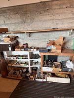 Overview of shelves with multiple cardboard boxes of plumbing fittings and supplies